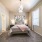 oversized windows brighten carpeted bedroom