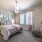 bedroom with large window and ceiling fan with light fixture